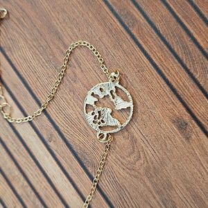 Goldtone bracelet globe world cut out design NWOT